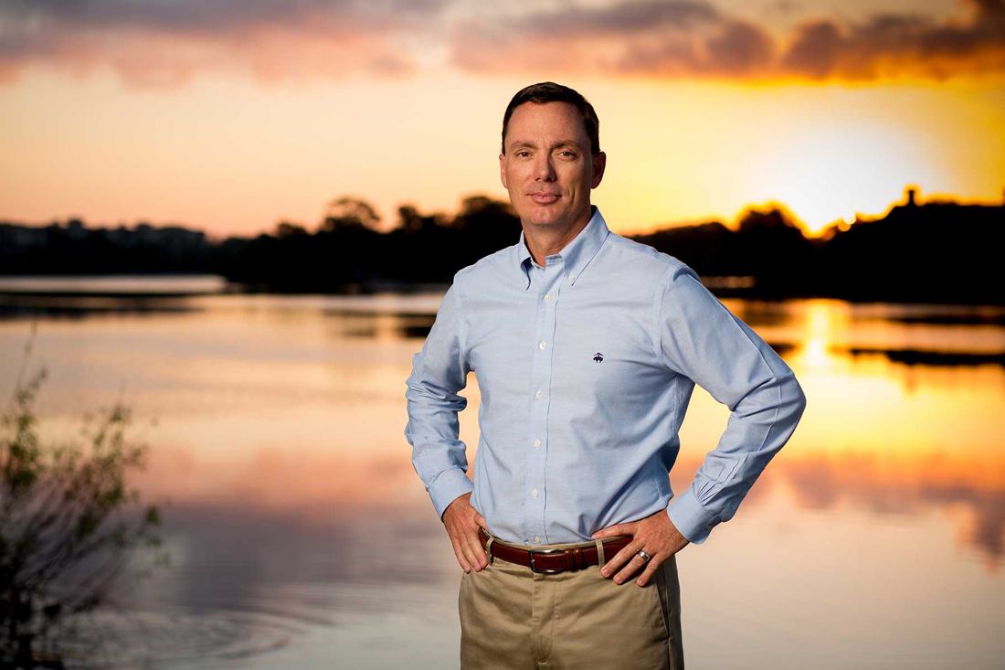 Portrait of a man beside the water at sunset